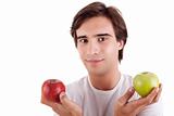 Portrait of a young man with two apples in their hands: green and red. Concept of choice