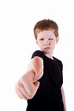 Portrait of a cute young boy, with thumb up