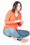 Portrait of pretty pregnant woman knitting