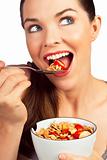 Beautiful young woman eating a healthy bowl of cereal with straw