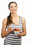 Beautiful young happy woman holding a healthy bowl of cereal