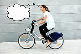 Young woman on a bike thinking