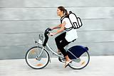 Young student going to university by bike