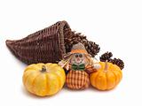Cornucopia with cones, pumpkins, and scarecrow doll