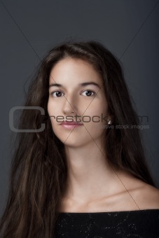 portrait of a woman with brown hair and brown eyes - isolated on gray