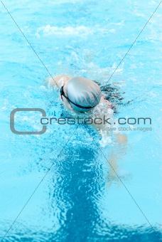 young woman swim on indoor pool close-up. freestyle mode.