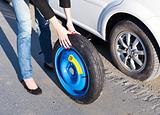 Woman changing the wheel