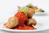 Meatballs on skewers with tomato sauce