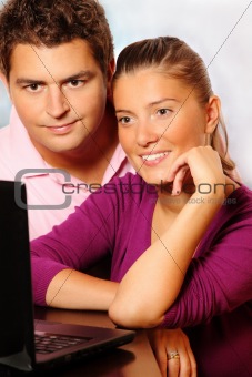Young married couple searching the Internet