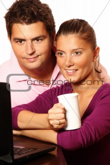 Young married couple working on laptop together
