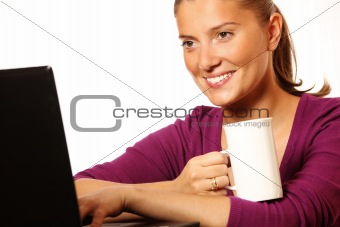 Young happy wife working on laptop