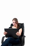 Young woman sitting in chair and is angry on a laptop