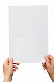 hands holding a white sheet of paper