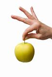 hand holding a yellow apple