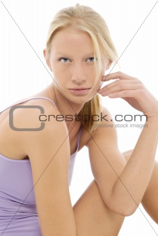 portrait of a young caucasian woman with purple top looks at the camera with sexy look
