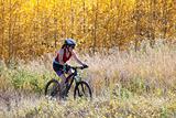 Woman mountain biking in autumn