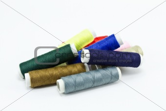 many colorful spools of thread