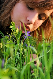 Girl bent over to the flower