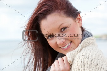 Smiling pregnant woman on the beach