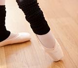 Close-up of the feet of a caucasian ballerina exercising