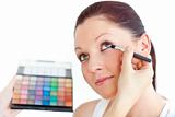 Charming woman being applied eye makeup
