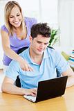 attractive woman showing something on the computer to her bf