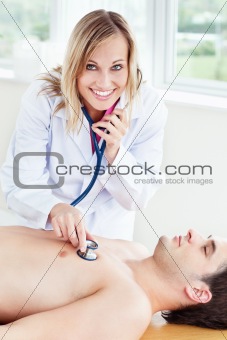 beautiful female doctor using stethoscope on a patient