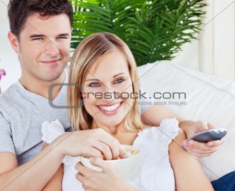 Young couple having fun in front of the TV