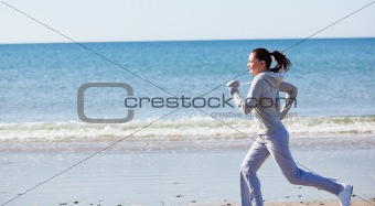 Attractive woman runnng on the beach 