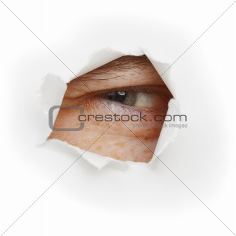 Squinting eye looks through a hole