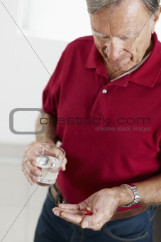 senior man taking medicine