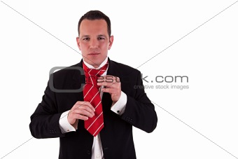 Businessman putting on tie