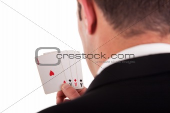 detail of the shore of a man with four cards with four aces in hand, isolated on white background, studio shot