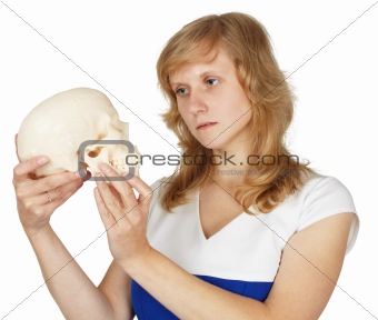 Student watches plastic human skull