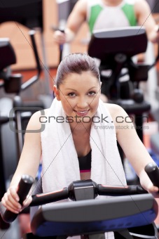 Athletic woman using a bicycle in a sport centre