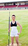 confident athletic woman ready to throw a javelin standing in a 