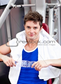 Handsome athlete holding a bottle of water