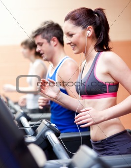 Beautiful female athlete standing on a treadmill