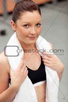 Captivating athletic woman with towel around the neck