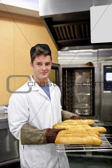 Happy baker showing his baguettes