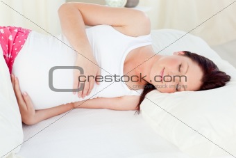 Radiant pregnant woman sleeping in her bed