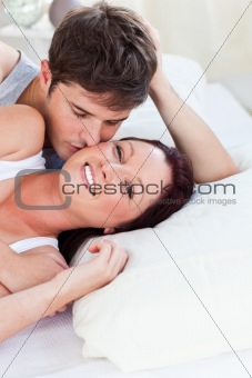 Loving caucasian couple lying on bed in the bedroom