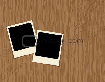 Two photo frames on wooden background 