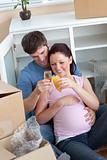 cheerful couple celebrating pregnancy and removal with champagne