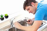 Manual man repairing a kitchen sink