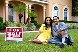 Happy African American Couple Beside House For Sale Sign