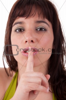 Young woman asking for silence , isolated on white background. Studio shot.