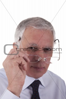 Portrait of a mature  businessman,putting the glasses,  on white background, studio shot