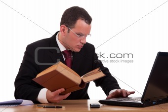 man on desk reading and studying, isolated on white background, studio shot.