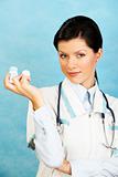 adult caucasian woman as a doctor holding meds